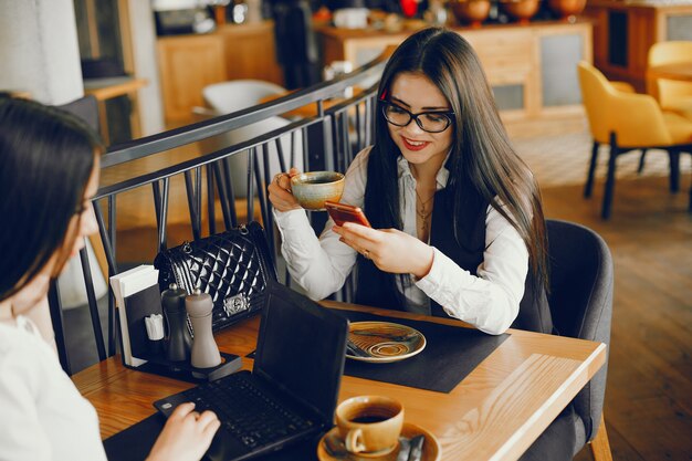 dos chicas de lujo sentados en un restaurante