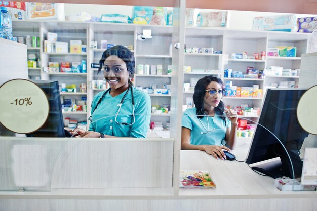 Dos farmacéuticos afroamericanos que trabajan en una farmacia en la farmacia del hospital Atención sanitaria africana