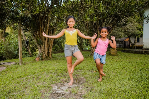 Dos hermanas jóvenes jugando juntas en el jardin