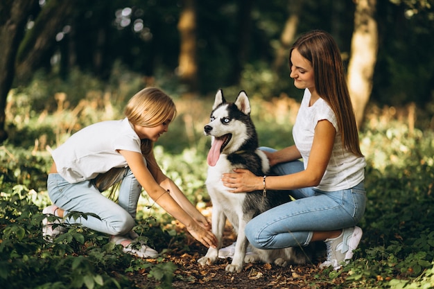 Dos hermanas con su perro en el parque.