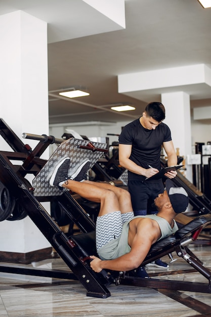 Foto gratuita a dos hombres guapos se dedica a un gimnasio.