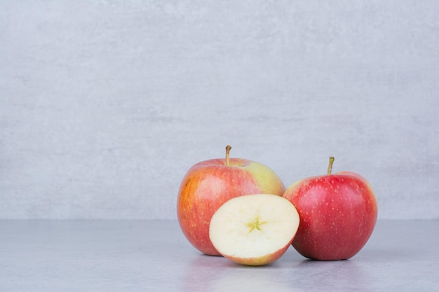 Dos manzanas enteras con rodajas sobre fondo blanco. Foto de alta calidad