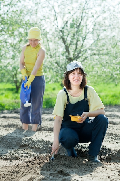 Dos mujeres siembran semillas