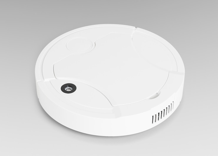 Foto gratuito electrónica doméstica aspiradora robot blanca