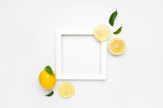 Elegante composición de juego de limones sobre una superficie blanca