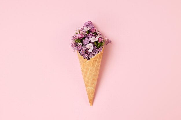 Elegante concepto de comida ecológica con flores en cono de helado