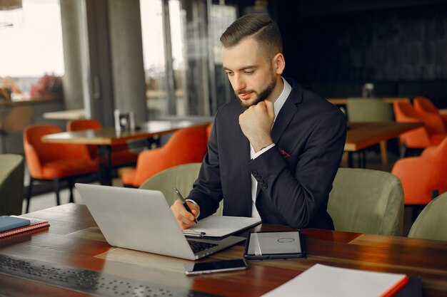 Elegante empresario trabajando en un café