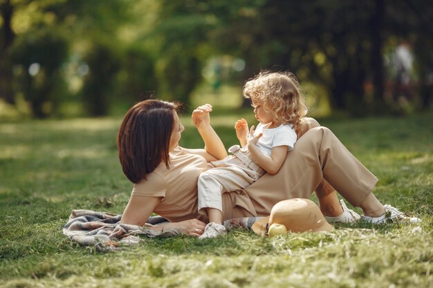 Elegante madre con hija en un parque de verano