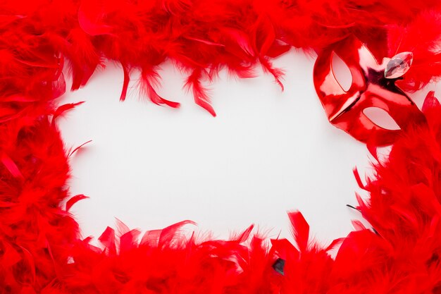 Elegante máscara de carnaval con plumas rojas