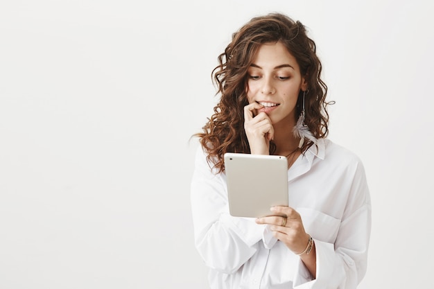 Foto gratuita elegante mujer joven mirando tableta digital, compras en línea