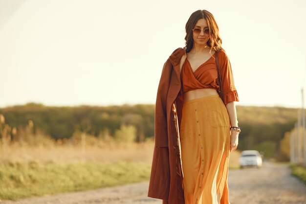 Elegante mujer pasar tiempo en un campo de verano