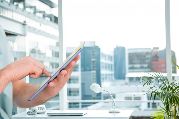 Empleado trabajando en su oficina con una tableta