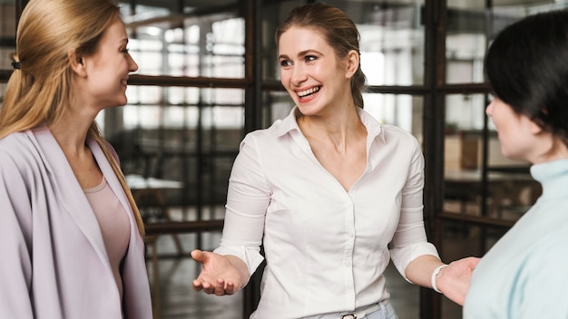 Empresarias sonrientes tener una conversación en el interior