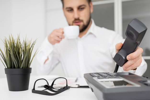 Empresario disfrutando de un café en la oficina