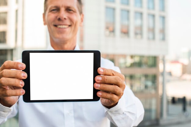 Empresario sosteniendo maqueta de tableta