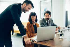 Foto gratuita empresarios sonrientes trabajando con el portátil