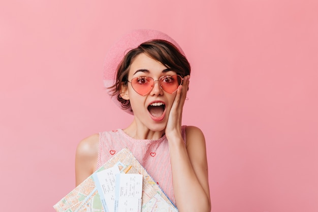 Encantadora mujer con gafas rosas esperando viajar