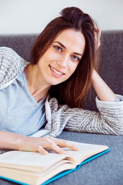 Encantadora mujer leyendo en el sofá