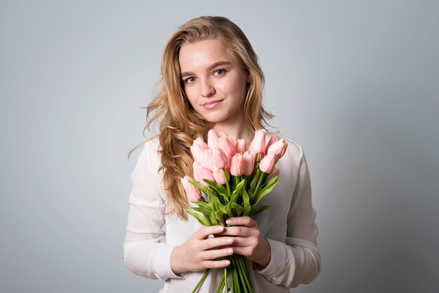 Encantadora mujer con ramo de flores.