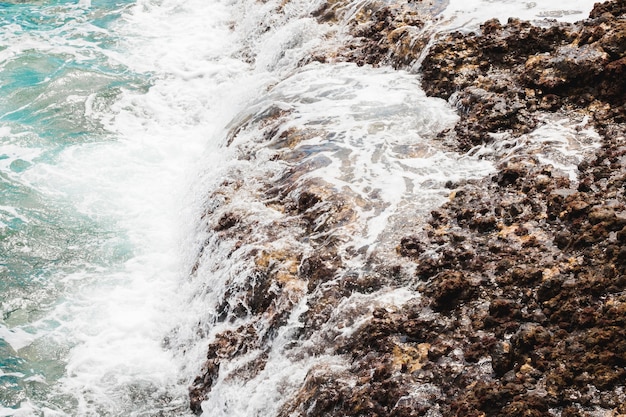 Por encima de las olas de vista en la costa rocosa