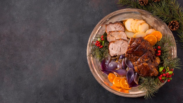 Endecha plana de bistec de navidad en un plato con decoración de piñas y espacio de copia