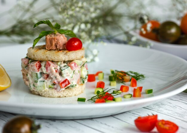 Ensalada de atún con tomate y pepino sazonada con mayonesa