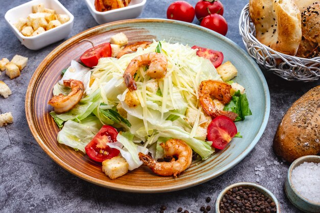 Foto gratuita ensalada césar de gambas con pan de lechuga relleno de tomate cherry y parmesano