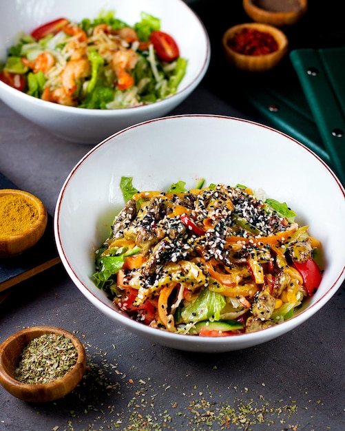 Ensalada de lechuga, tomate, salsa y ajonjolí