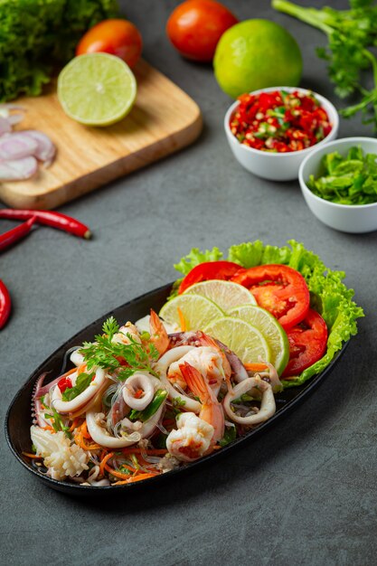 Ensalada picante de mariscos mixtos con ingredientes de comida tailandesa.