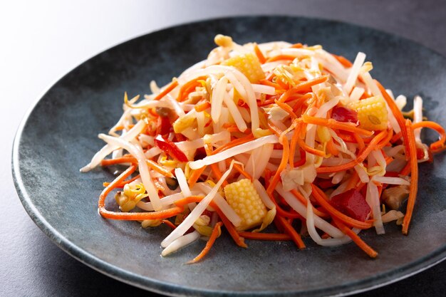 Ensalada de repollo chino saludable en plato sobre fondo de pizarra negra