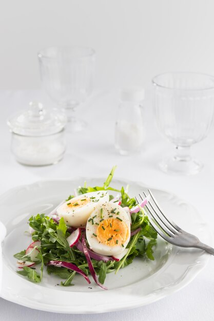 Ensalada saludable con huevo en un surtido de plato blanco