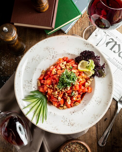 Ensalada de tomate y nueces con rodaja de limón