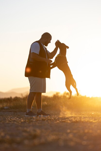 Entrenador de perros saltando con perro