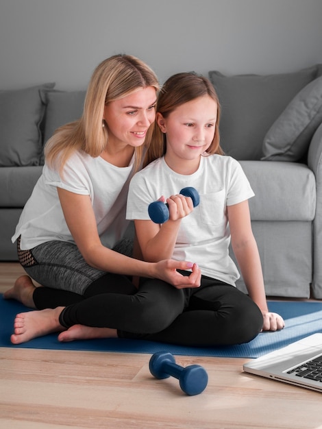 Entrenamiento de mamá y niña después de videos del portátil