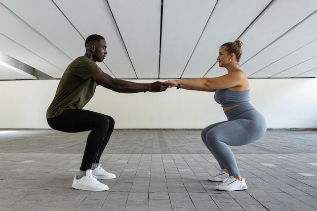 Foto gratuita entrenamiento de mujer y hombre de tiro completo