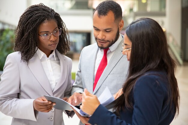 Equipo de negocios enfocado leyendo el acuerdo juntos