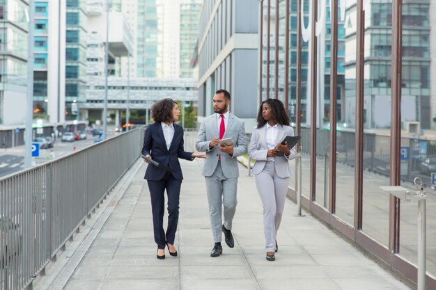 Equipo de profesionales de negocios hablando en la calle