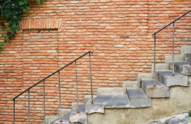 Escaleras en el fondo de una pared de ladrillos, las calles de la ciudad vieja, la idea de un protector de pantalla o un artículo sobre viajes y un entorno urbano cómodo Espacio libre