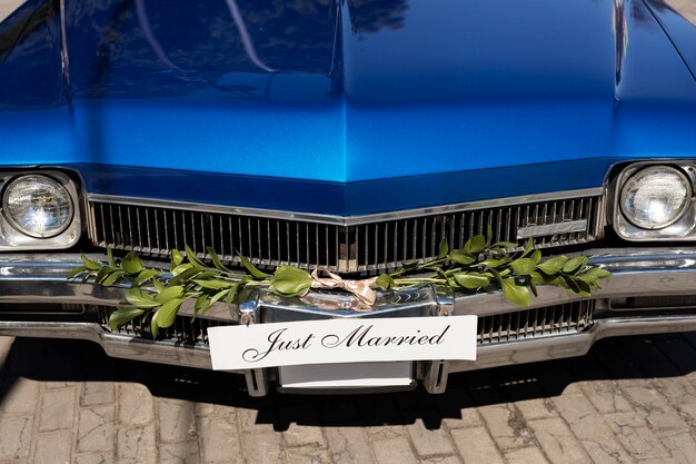 Escena de coche de recién casados con flores.