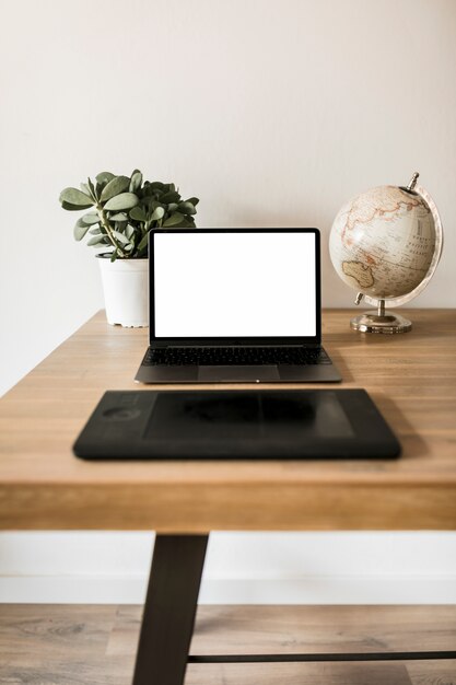 Escritorio con ordenador portátil y tablet gráfica