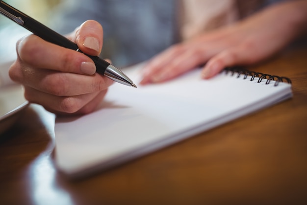 Escritura de la mujer en la libreta