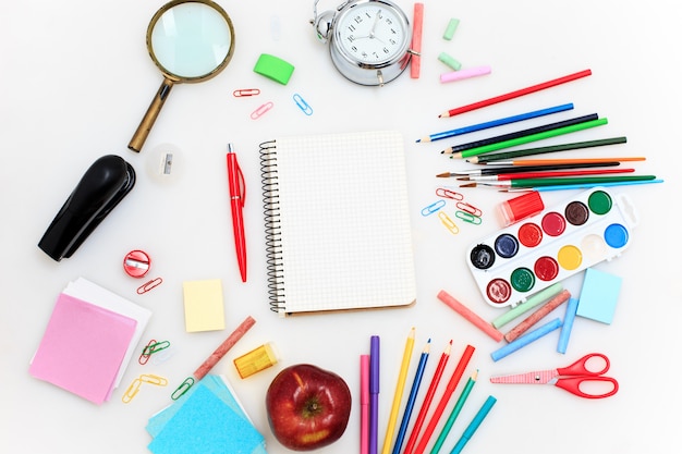 Escuela con cuadernos sobre fondo blanco.