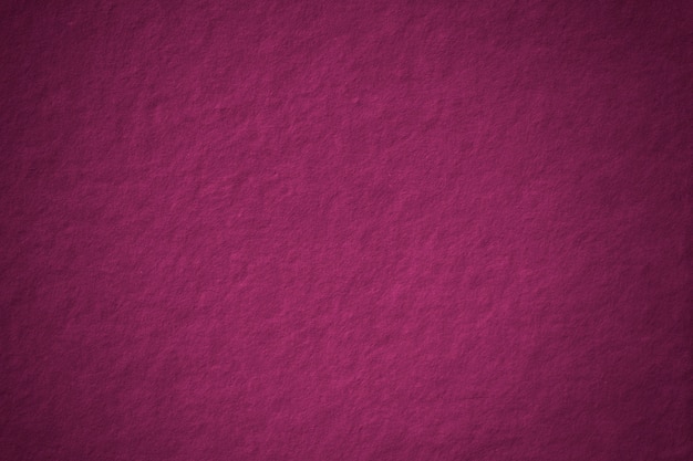 Espacio en blanco de fondo con textura de hormigón magenta con viñeta