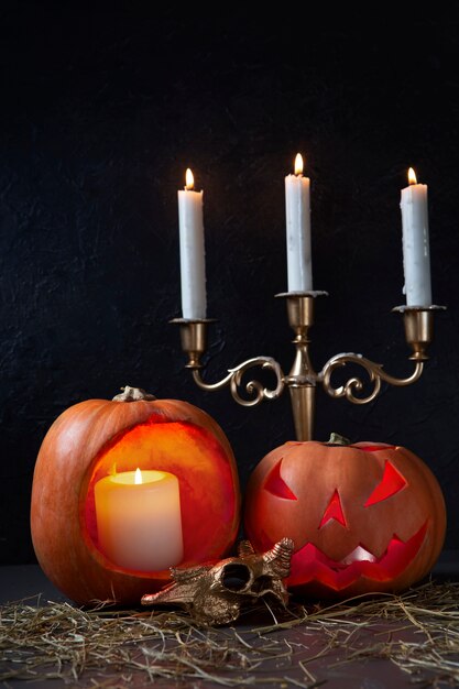 Espeluznante linterna de calabaza tallada de halloween con candelabros