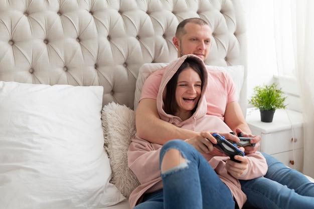 Esposa y esposo jugando videojuegos en casa
