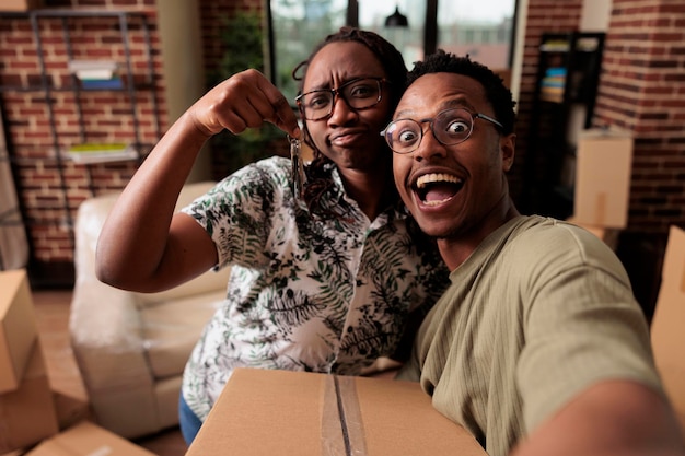 Foto gratuita el esposo y la esposa celebran la compra de bienes raíces para mudarse, tienen las llaves del apartamento. disfrutando de la reubicación de la propiedad y celebrando el evento de la relación, sintiéndome entusiasmado con el futuro.