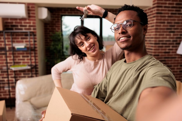 El esposo y la esposa compran un nuevo apartamento y tienen llaves de la casa, celebran el evento de relación siendo propietarios de una propiedad. Mudanza en piso de bienes raíces juntos, comprado en préstamo hipotecario.