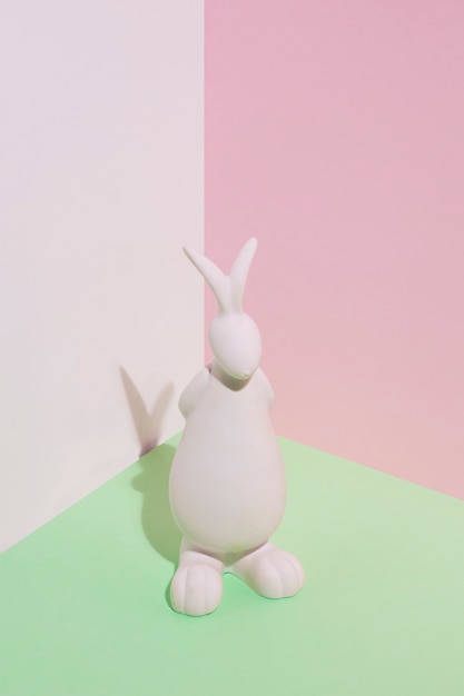 Estatuilla de conejo blanco en mesa verde
