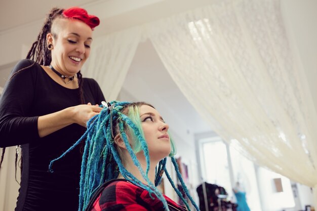 Esteticista peinando el cabello de los clientes