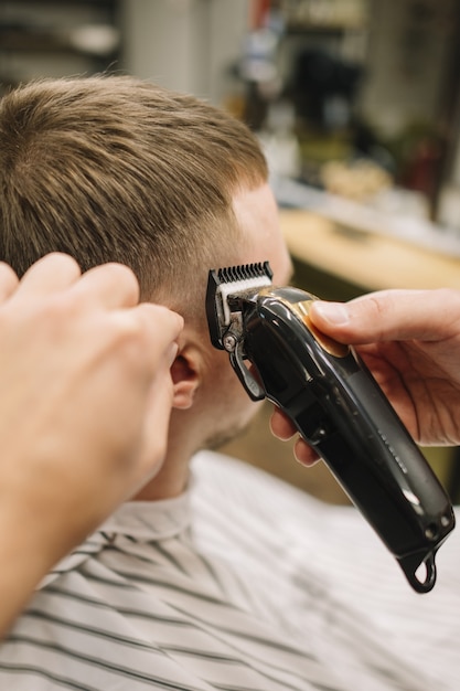 Foto gratuita estilista dando un corte de pelo a un cliente